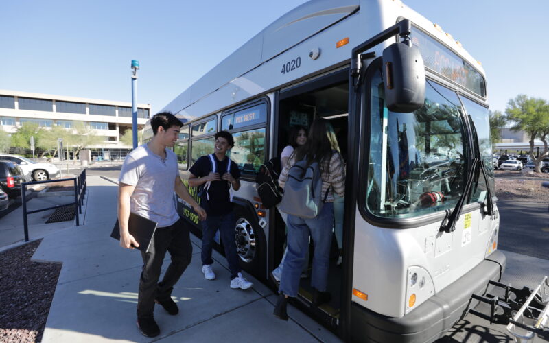 Students talking about boarding the bus.