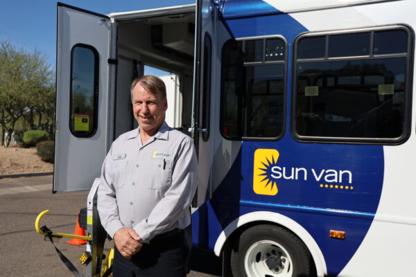 Sun Van Operator in front of Sun Van vehicle